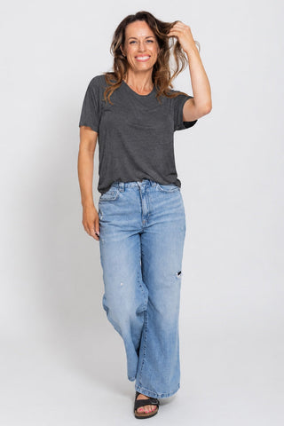 Classic Bamboo T-Shirt in Dark Grey Marle, full length front view on model with hand in hair, styled with wide leg jeans.