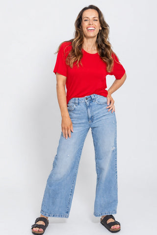 Classic Bamboo T-Shirt in Red, full length front view on model with hand on hip, styled with wide leg jeans and sandals.