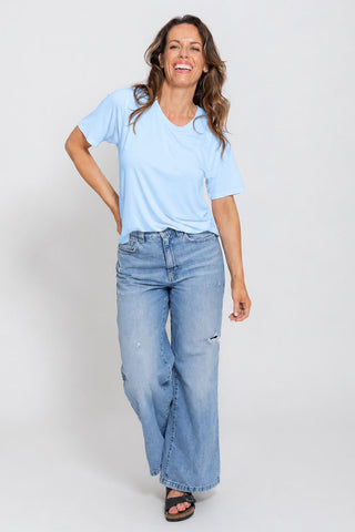 Classic Bamboo T-Shirt in Sky Blue, full length front view on model with hand on hip, styled with wide leg jeans.