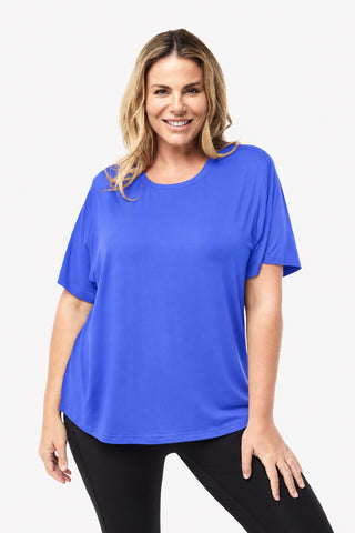 Classic Bamboo T-Shirt in Cobalt Blue, front view on model smiling, styled with black leggings.