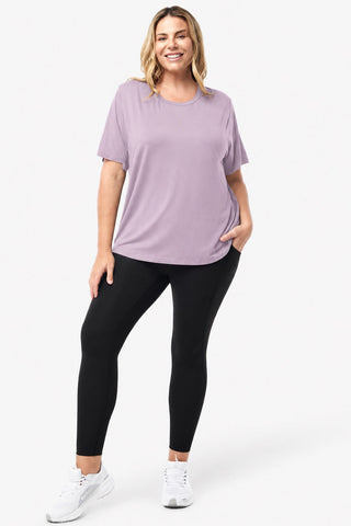 Classic Bamboo T-Shirt in Purple Haze, full length front view on model with hand in pocket, styled with black leggings and white sneakers.