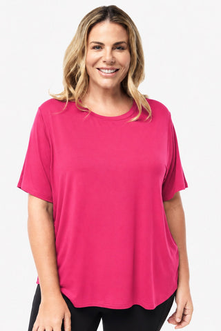Classic Bamboo T-Shirt in Raspberry, front view on model smiling, styled with black leggings.