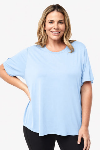 Classic Bamboo T-Shirt in Sky Blue, front view on model with hand on hip, styled with black leggings.