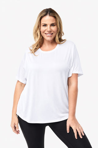 Classic Bamboo T-Shirt in White, front view on model with hands on thighs, styled with black leggings.