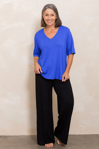 Bamboo V-Neck T-Shirt in Cobalt Blue, full length front view on model, styled with black wide leg pants.