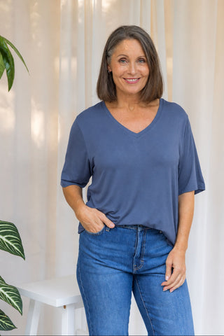 Bamboo V-Neck T-Shirt in Denim Blue, front view on model with hand in pocket, styled with denim jeans.