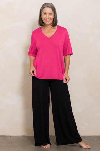 Bamboo V-Neck T-Shirt in Raspberry, full length front view on model, styled with black wide leg pants.