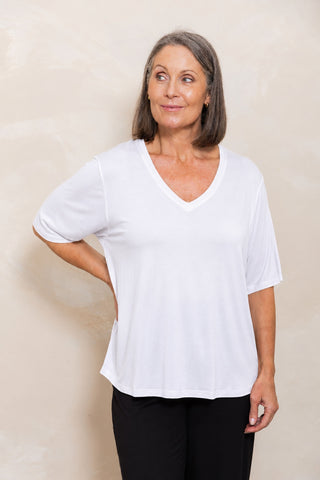 Bamboo V-Neck T-Shirt in White, front view on model with hand on hip, styled with black pants.