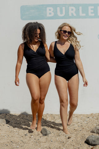 Burleigh Core Support One Piece Swim in Black Texture, front view on two models walking on the beach