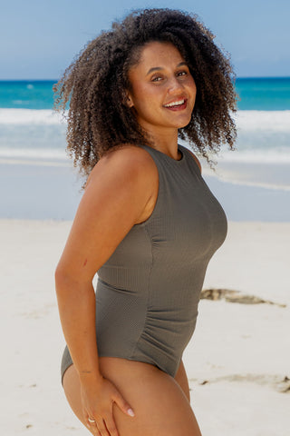 Coogee Core Support One Piece Swim in Khaki Texture, side view on model at the beach