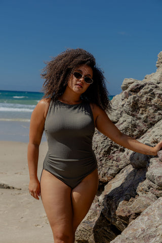 Coogee Core Support One Piece Swim in Khaki Texture, front view on model leaning on a rock