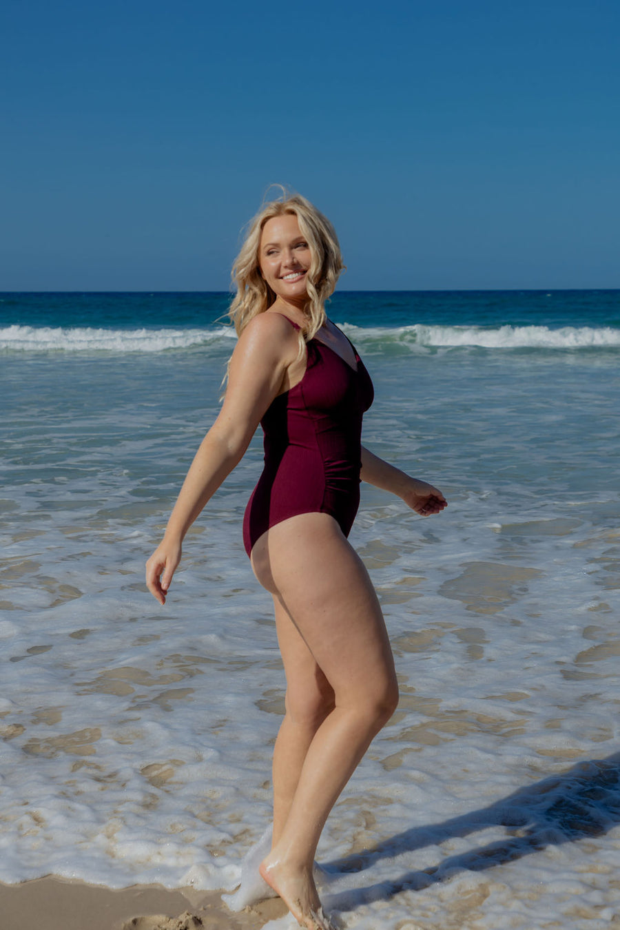 Coolum Core Support One Piece Swim in Dark Cherry Texture, full body view on model walking through the waves.

Model: Model wears a size M. She is size 12 and 172cm tall.