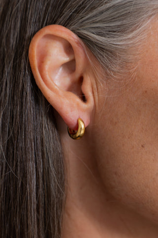 Stainless Steel Small Hoop Earring in Gold, close up worn in a model ear.