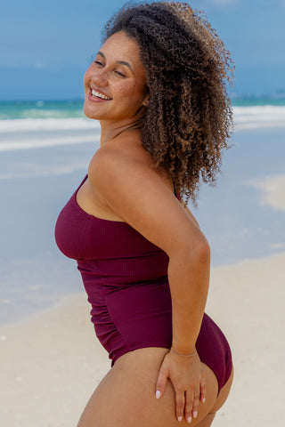 Esperance Core Support One Piece Swim in Dark Cherry Texture, side view on model looking over her shoulder