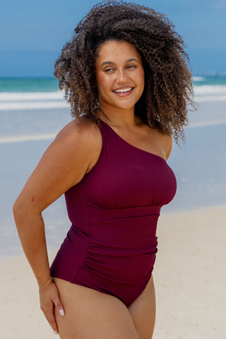 Esperance Core Support One Piece Swim in Dark Cherry Texture, side view on model showing the side ruching
