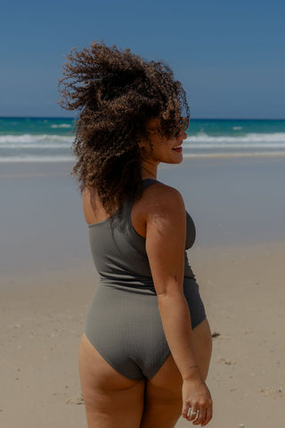 Esperance Core Support One Piece Swim in Khaki Texture, back view on model looking over her shoulder