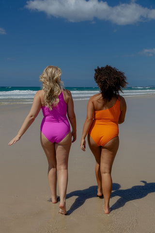 Esperance Core Support One Piece Swim in Orange Pop Texture, back view on two models walking on the beach