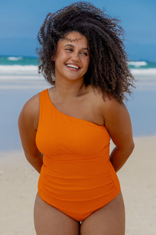Esperance Core Support One Piece Swim in Orange Pop Texture, front view on model showing the one shoulder neckline