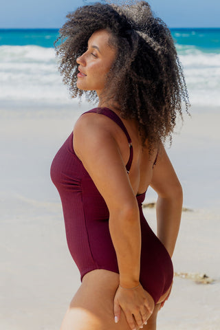 Sorrento Core Support One Piece Swim in Dark Cherry Texture, side view on model looking over her shoulder