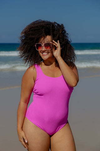 Sorrento Core Support One Piece Swim in Hot Pink Texture, front view on model at the beach