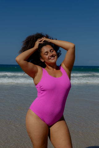 Sorrento Core Support One Piece Swim in Hot Pink Texture, front view on model with arms raised
