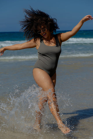Sorrento Core Support One Piece Swim in Khaki Texture, front view on model splashing in the surf