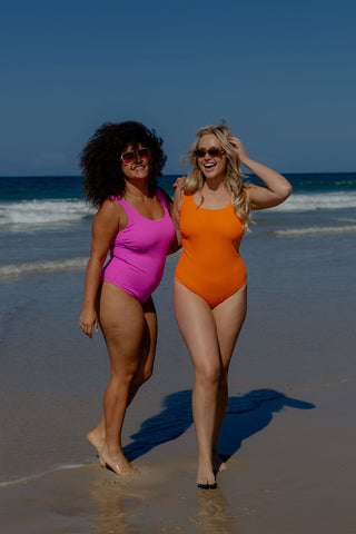 Sorrento Core Support One Piece Swim in Orange Pop Texture, front view on model beside a second model in Hot Pink